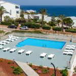 Swimming pool with surrounding sunbeds to enjoy the day